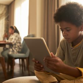 medium-shot-kid-holding-tablet-266×266