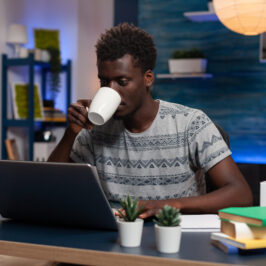 African american employee holding cup of coffee African american employee holding cup of coffee