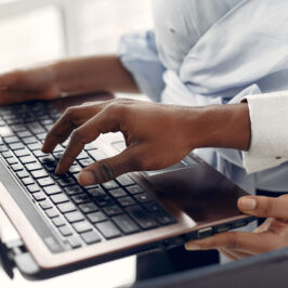 Black people standing on a white background with a laptop